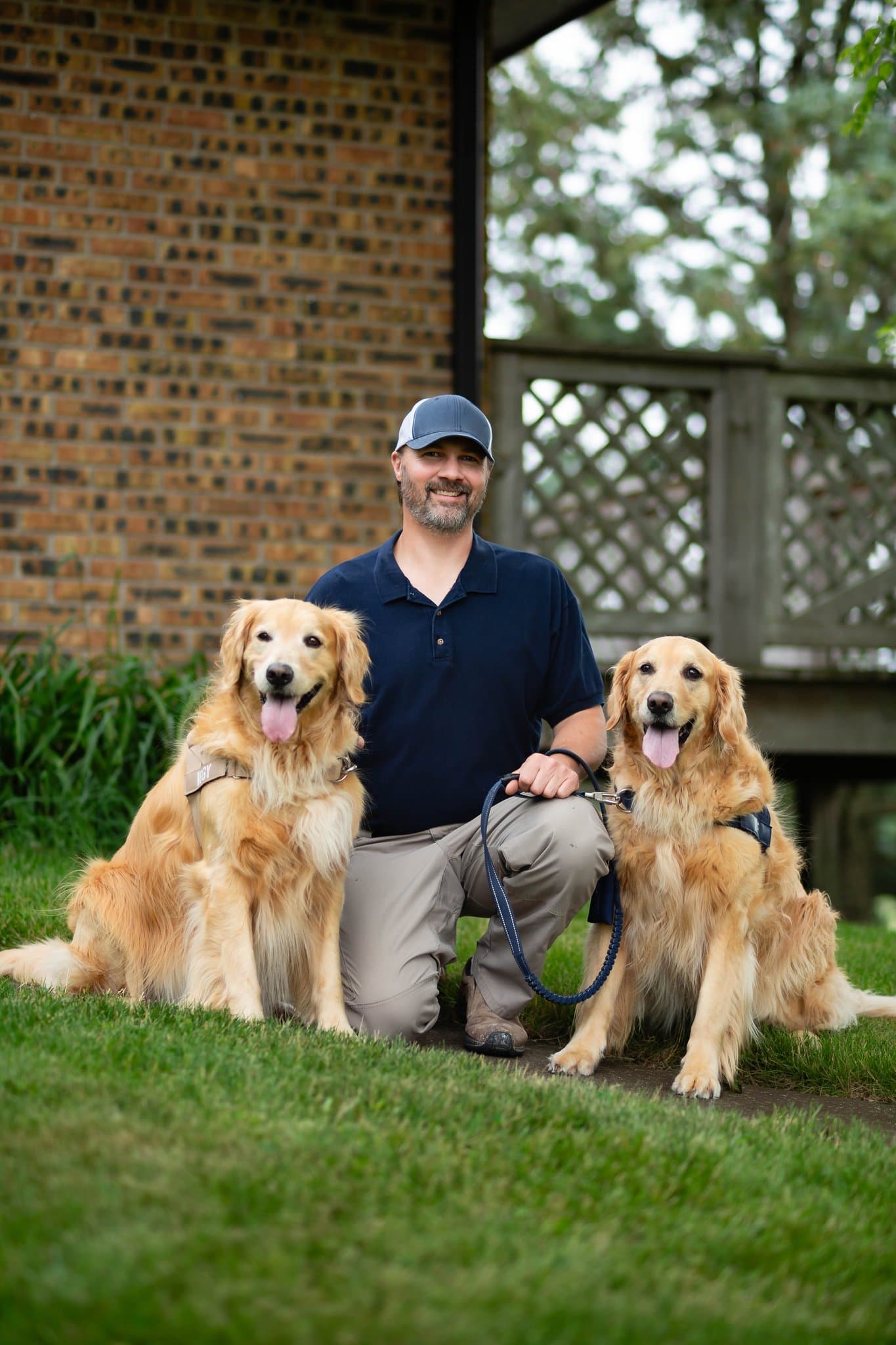 Mike Lacheta, owner of Retriever Home Inspection, with his two golden retrievers Iggy and Ike
